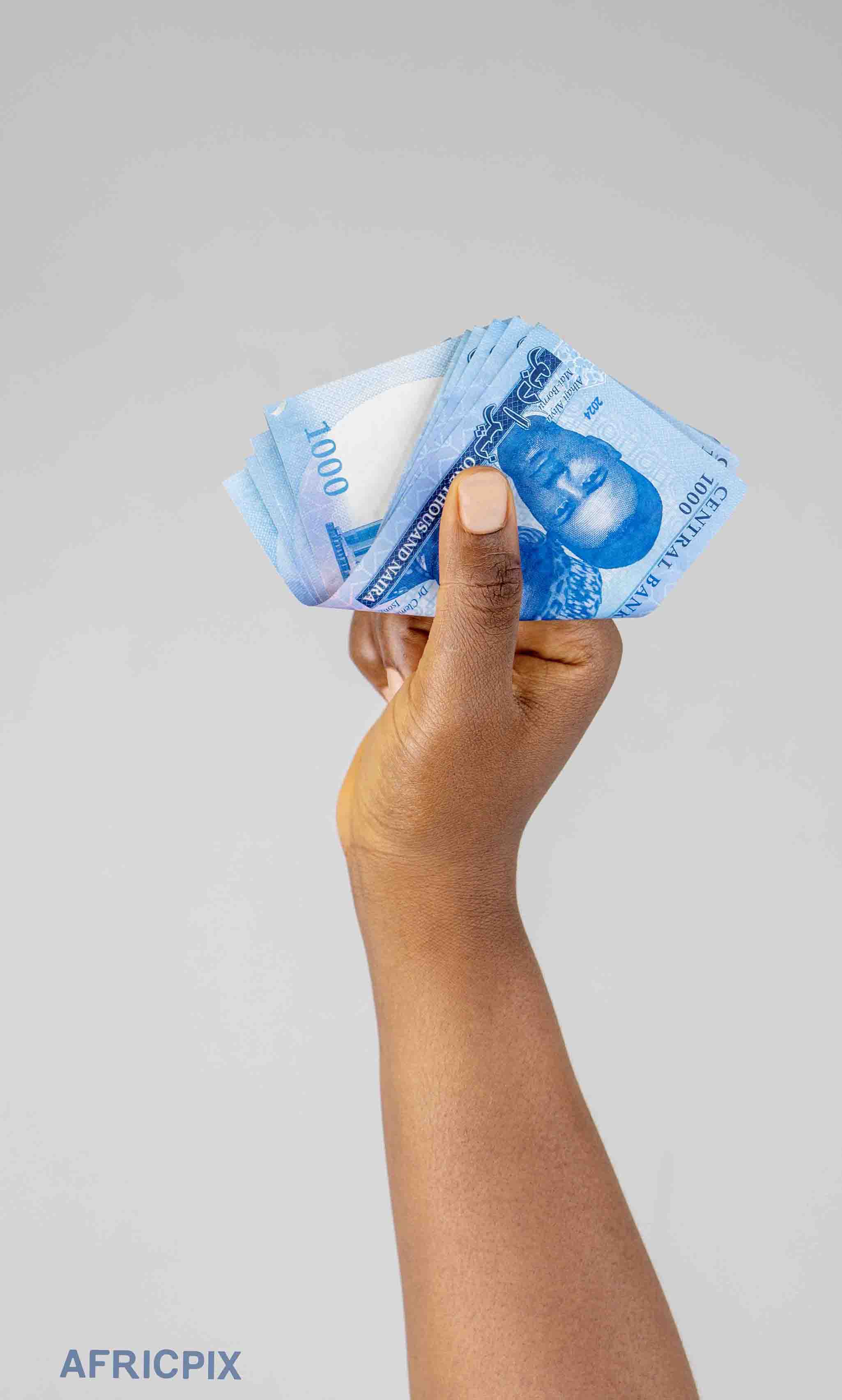 Hand Holding 1000 Naira Note